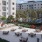 an outdoor courtyard with grills and tables